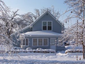 Snow and ice covered house after ice storm and blizzard, blue and white.